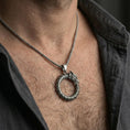 Load image into Gallery viewer, Oxidized sterling silver ouroboros dragon pendant worn on neck, tail-devourer eternity symbol necklace on braided chain, lifestyle close-up
