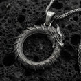 Load image into Gallery viewer, Oxidized sterling silver ouroboros dragon pendant on volcanic rock, tail-devourer eternity symbol necklace, macro close-up
