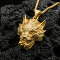 Load image into Gallery viewer, Gold plated Chinese dragon head pendant necklace on dark volcanic rock, mythic Asian dragon charm, premium macro lighting
