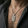 Load image into Gallery viewer, Polished silver dragon phoenix yin yang pendant worn on neck, balanced harmony necklace, clean lifestyle close-up
