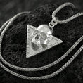 Load image into Gallery viewer, Polished silver Absolute’s talisman skull necklace on porous volcanic stone, BG3 inspired pendant, detailed studio shot
