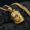 Load image into Gallery viewer, Gold plated Greek warrior helmet pendant necklace on volcanic rock, premium macro shot emphasizing the helmet relief, crisp borders, and bold shine
