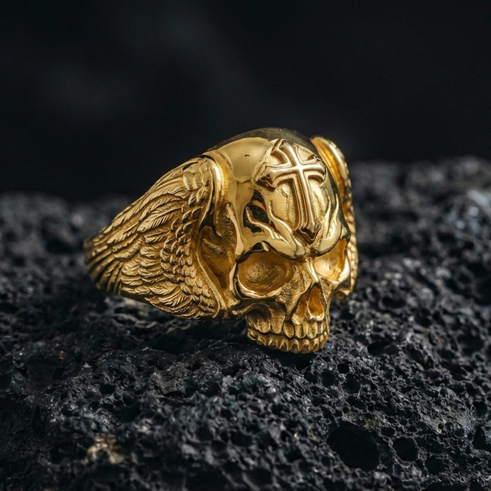 Gold plated skull ring with cross on dark volcanic rock, memento mori statement ring, premium studio macro photo
