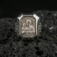 Load image into Gallery viewer, Polished silver St Joseph signet ring on porous volcanic stone, octagonal bezel, detailed saint medal engraving close-up
