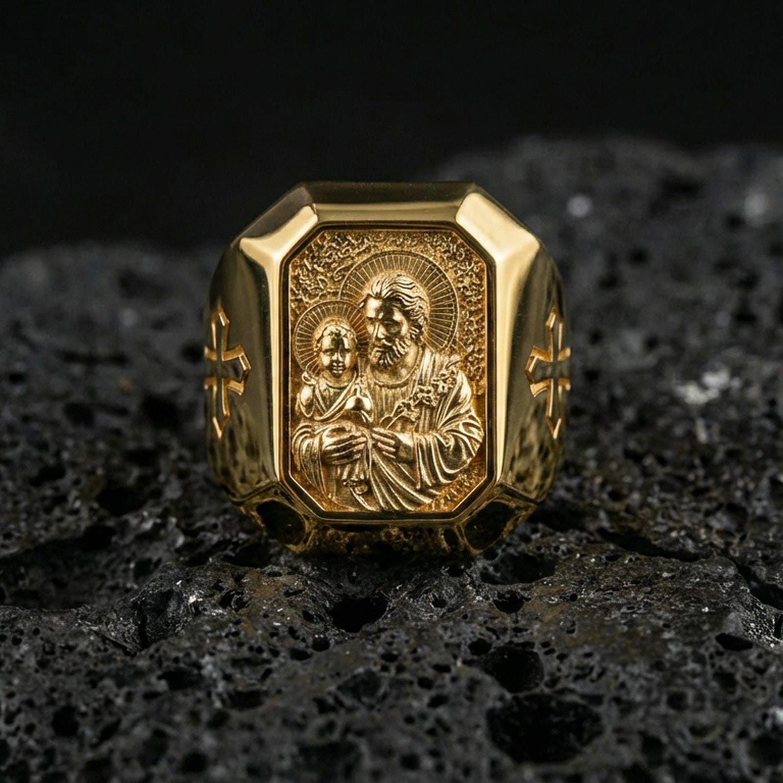 Gold plated St Joseph signet ring on dark volcanic rock, Catholic saint jewelry, bold religious mens statement ring