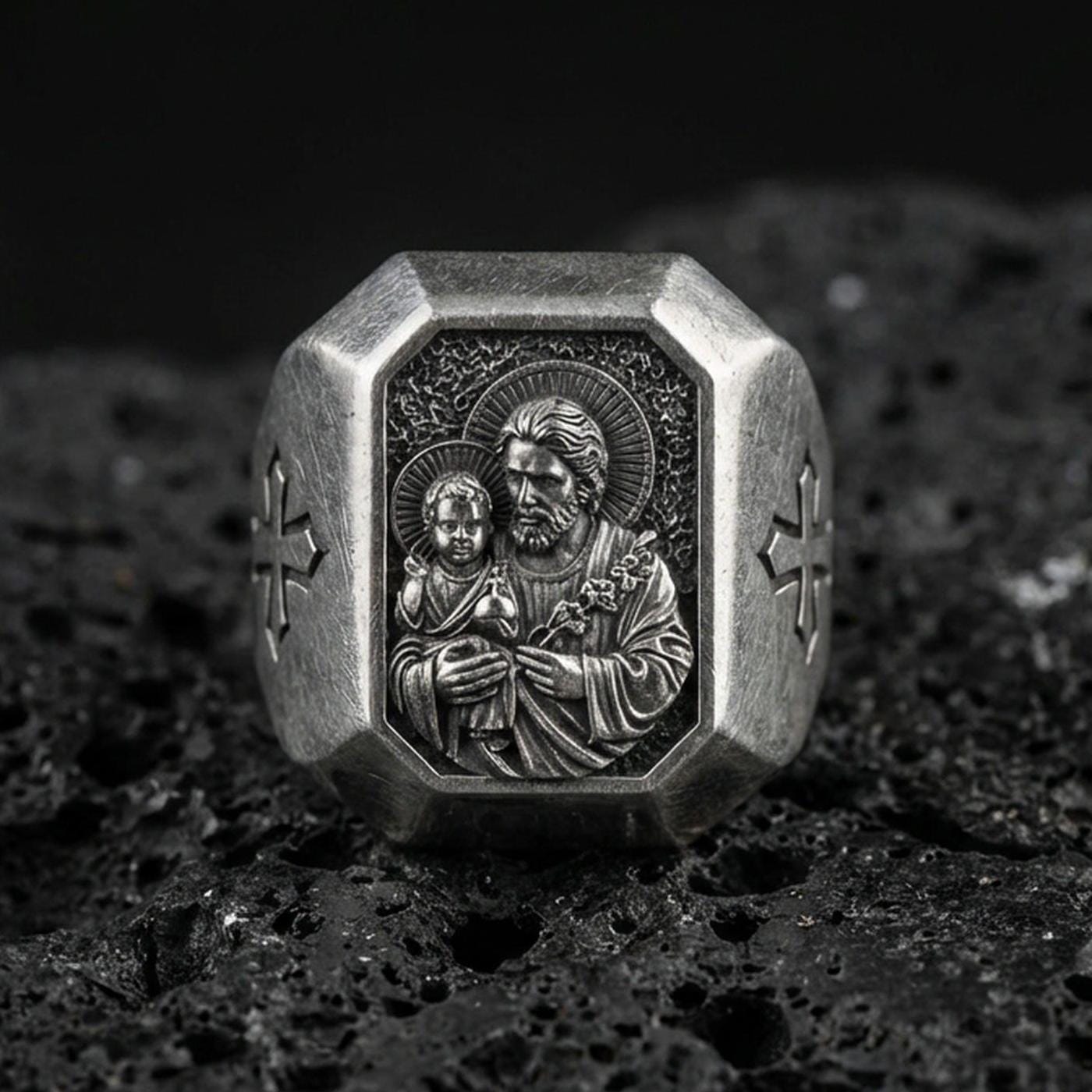Oxidized sterling silver St Joseph signet ring on volcanic rock, octagon face, Holy family relief, Catholic mens ring macro