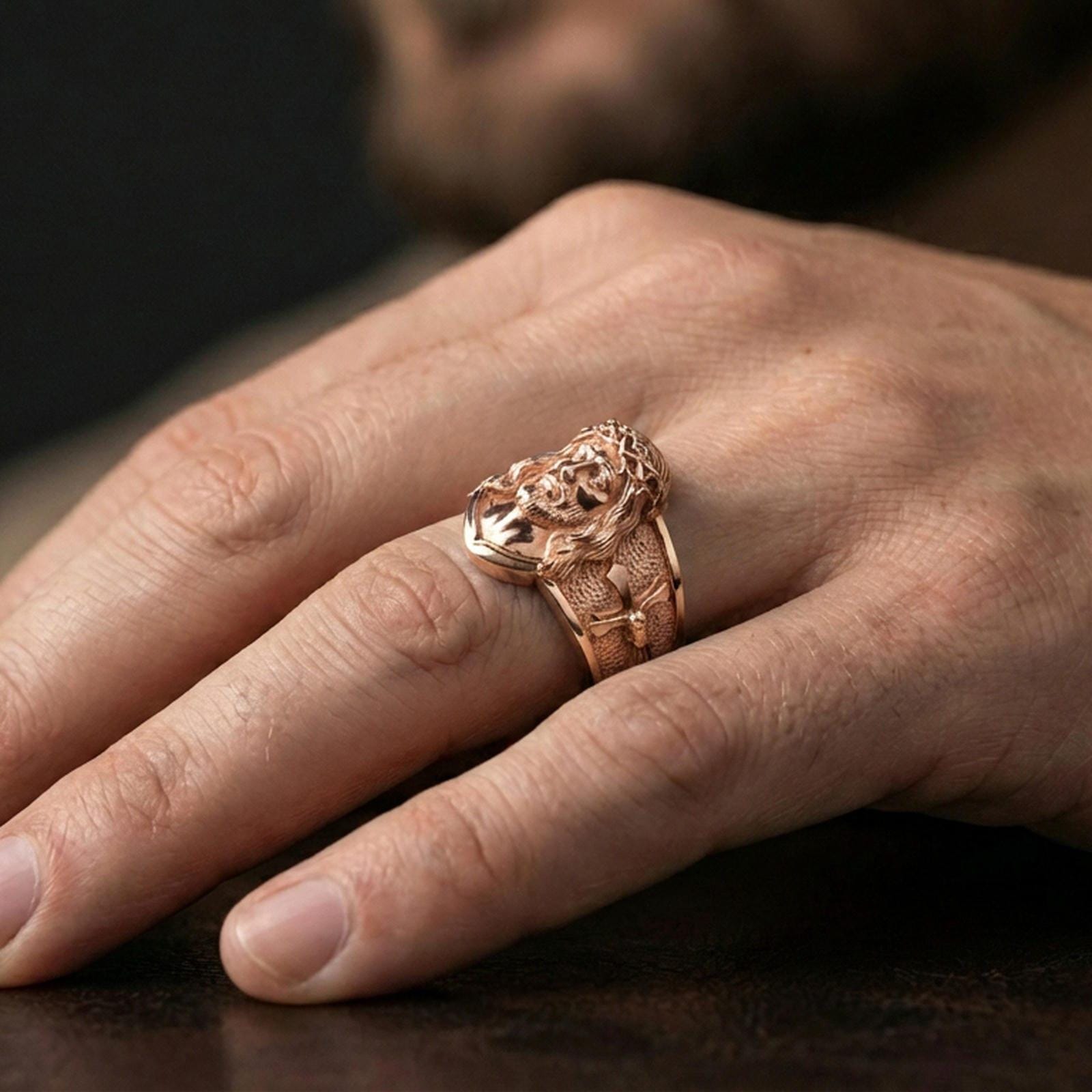 Rose gold plated Jesus Christ ring worn on finger, Christ face relief ring, Christian religious jewelry lifestyle photo