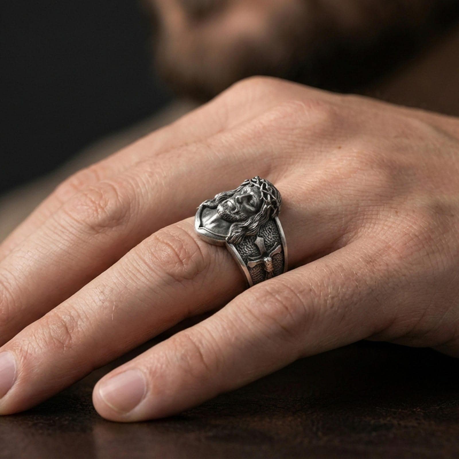 Oxidized sterling silver Jesus Christ ring worn on finger, crowned Christ face relief, cross band, mens Christian jewelry