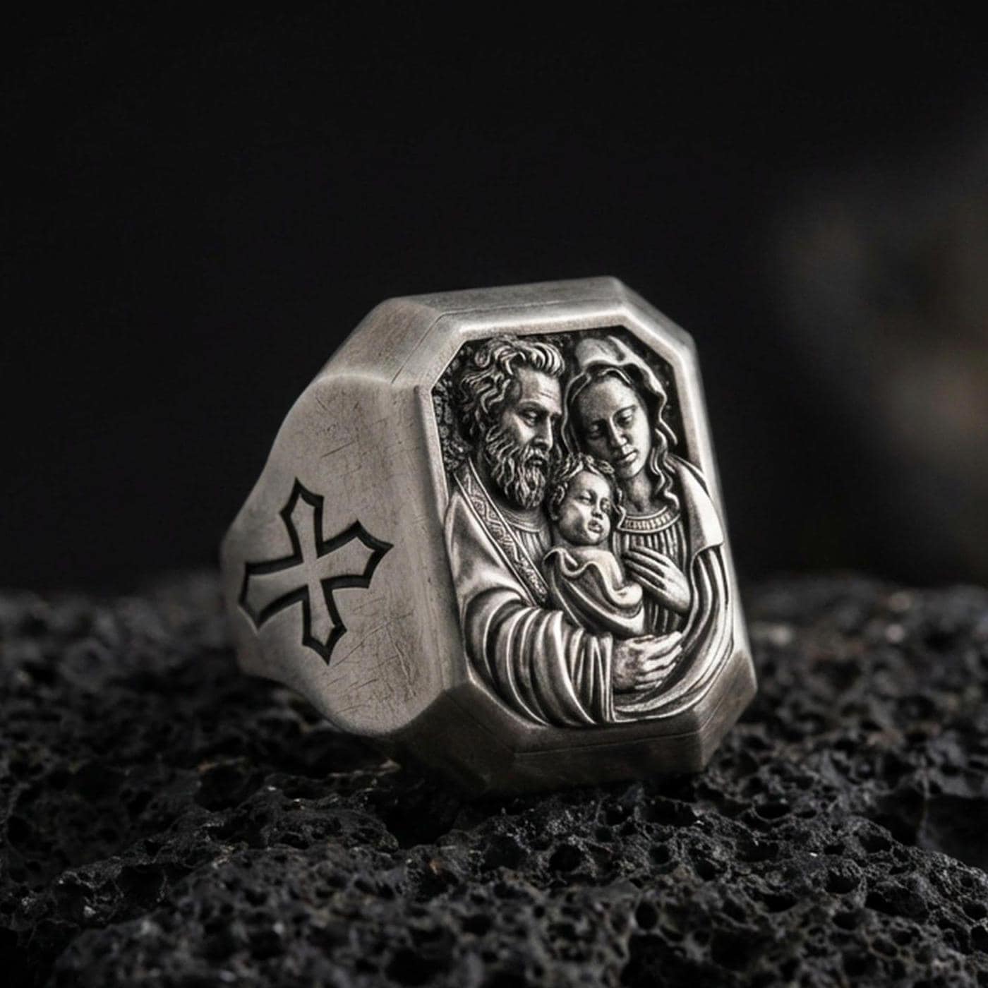 Oxidized sterling silver Holy Family ring on volcanic rock, St Joseph Mary and infant Jesus relief, cross side detail