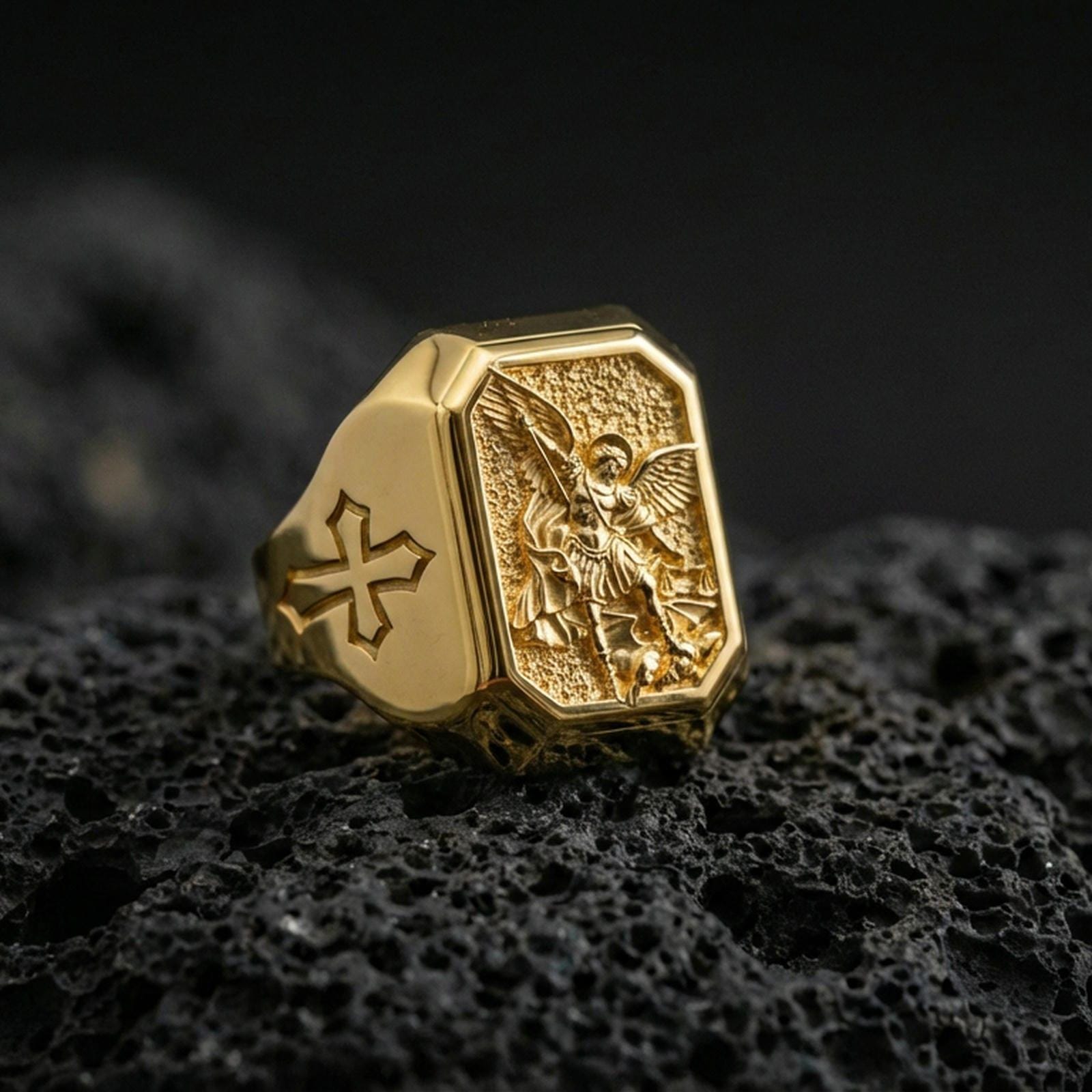 Gold plated Saint Michael signet ring on dark volcanic rock, archangel protector relief, Knights Templar cross side