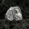 Load image into Gallery viewer, Polished silver St Francis ring on porous volcanic stone, detailed saint halo relief, Christian signet style
