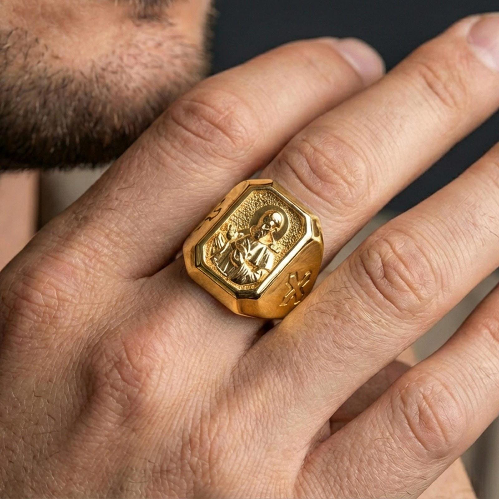 Gold plated St Francis ring worn on finger, cross side view, saint relief signet ring for men