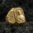 Load image into Gallery viewer, Gold plated St Francis signet ring on dark volcanic rock, saint portrait relief, cross side detail
