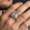 Load image into Gallery viewer, Polished silver St Francis signet ring worn on finger, detailed halo portrait, Christian devotion jewelry
