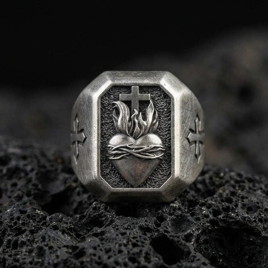 Oxidized sterling silver cross heart signet ring on volcanic rock, sacred heart flame relief, cross side engraving