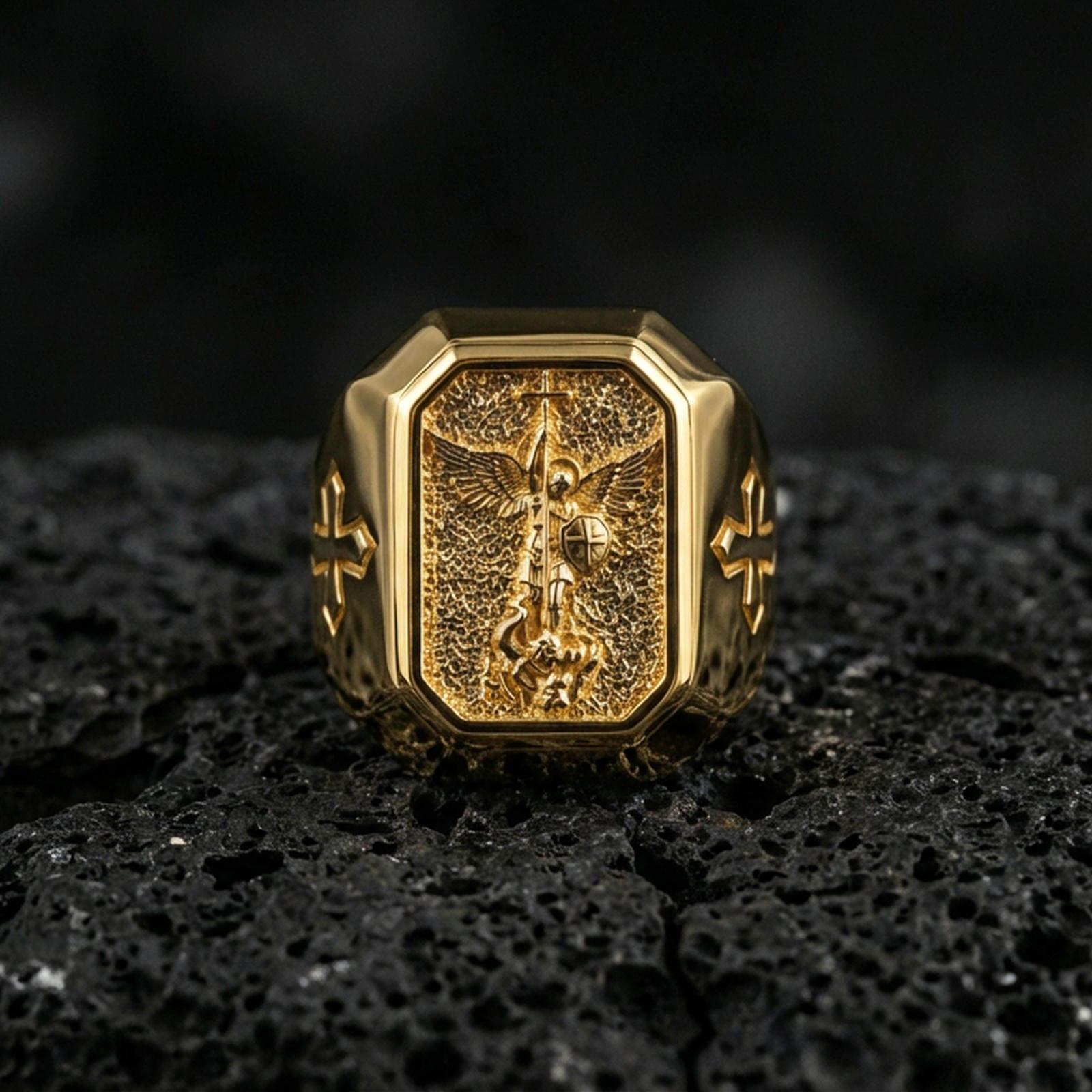 Gold plated St Michael archangel signet ring on dark volcanic rock, winged guardian motif, cross side details