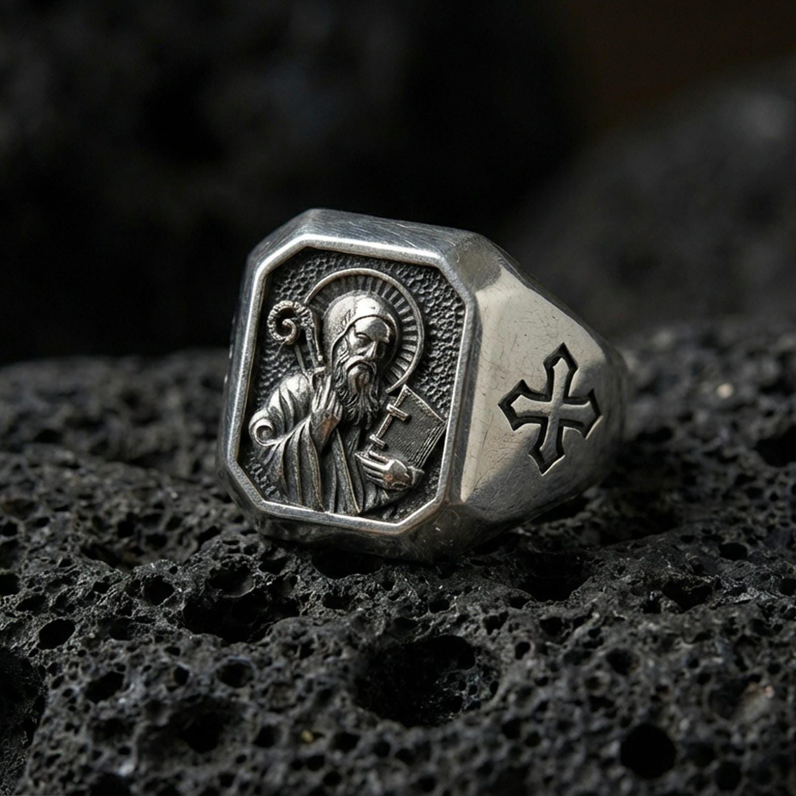 Oxidized sterling silver Saint Benedict signet ring on volcanic rock, engraved saint icon, cross shoulder detail