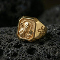 Load image into Gallery viewer, Gold plated Saint Benedict signet ring on dark volcanic rock, detailed saint engraving, cross side accent
