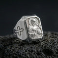 Load image into Gallery viewer, Polished silver Saint Francis ring on porous volcanic stone, halo relief engraving, Christian signet jewelry
