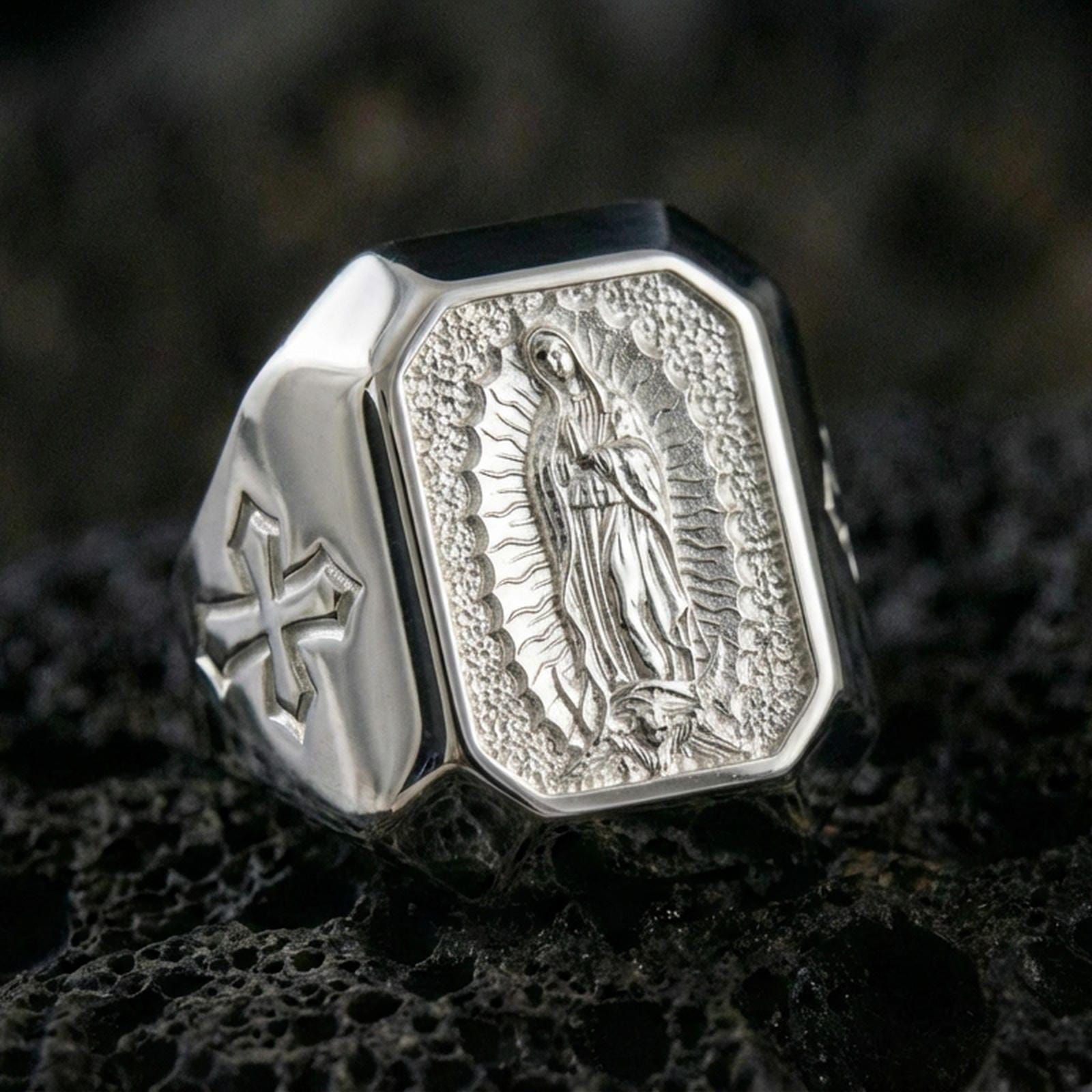 Polished silver Our Lady of Guadalupe ring on porous volcanic stone, detailed Virgin Mary engraving, Catholic signet jewelry