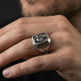 Load image into Gallery viewer, Oxidized sterling silver St Anthony ring worn on finger, saint holding child relief, cross shoulder detail close-up
