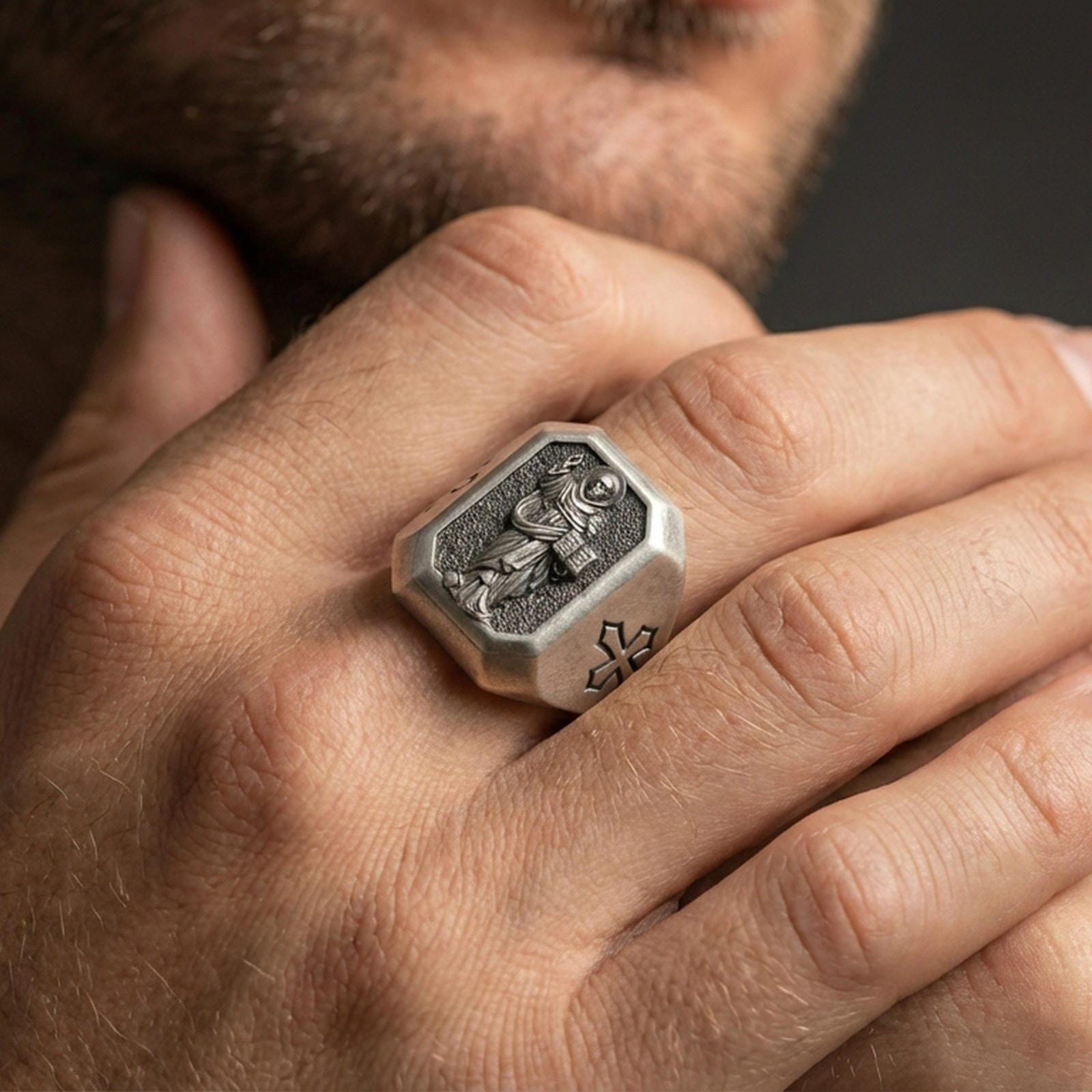 Oxidized sterling silver St Dominic ring worn on finger, saint relief with book, cross shoulder detail close-up