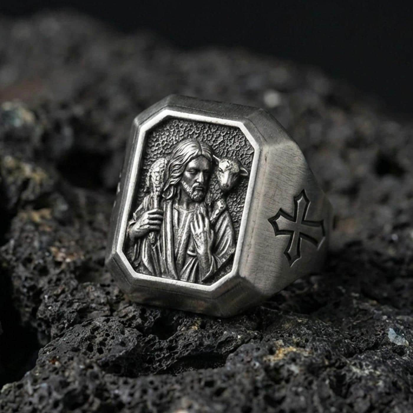 Oxidized sterling silver Jesus Shepherd signet ring on volcanic rock, Good Shepherd relief with lamb, cross side engraving