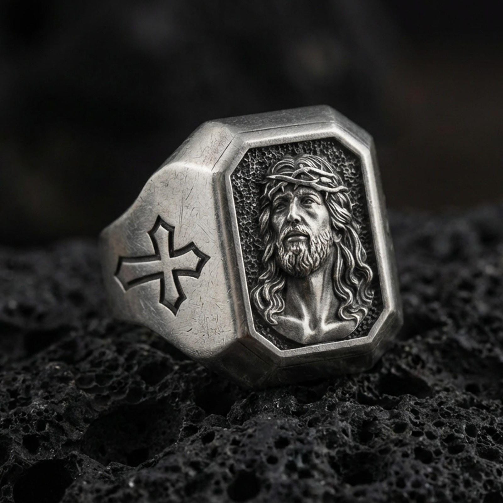 Oxidized sterling silver Jesus Christ signet ring on volcanic rock, crown of thorns portrait relief, cross side engraving