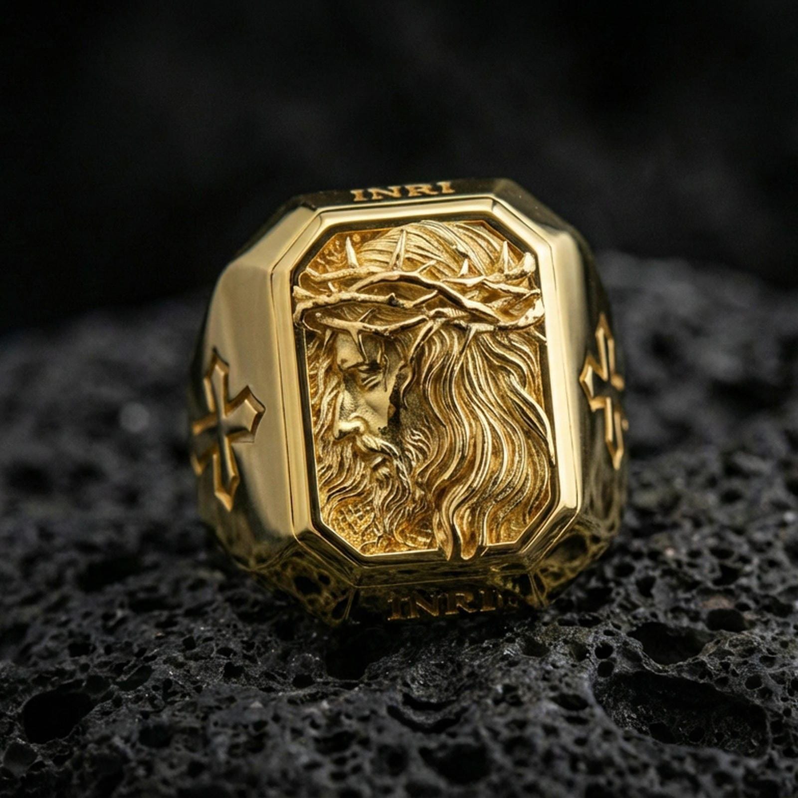 Gold plated Jesus Christ crown of thorns ring on dark volcanic rock, side-profile relief engraving, cross side details close-up