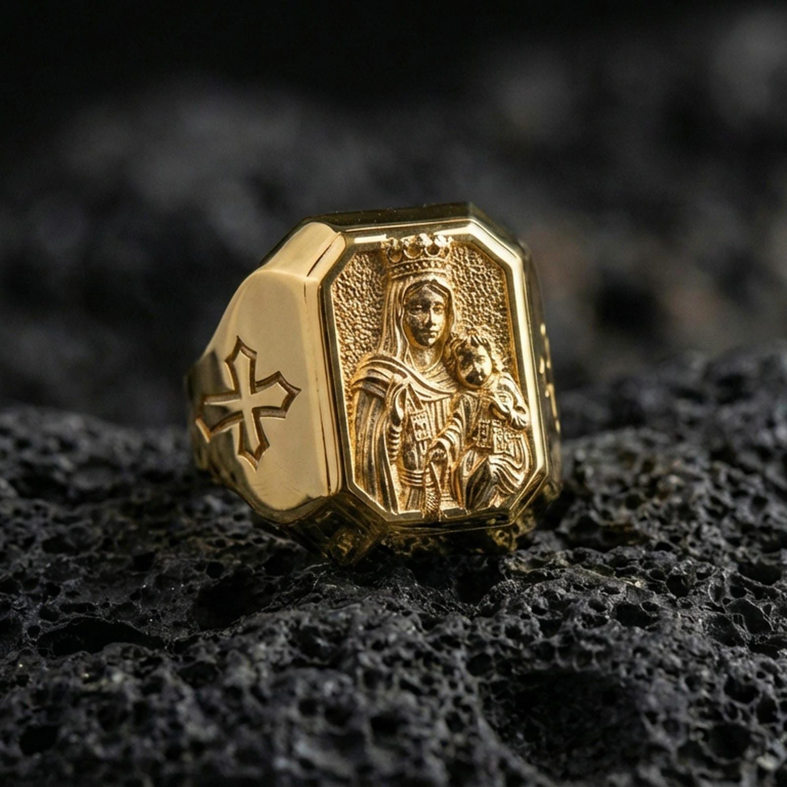 Gold plated Virgin Mary and Child ring on dark volcanic rock, crowned Madonna relief engraving, Christian signet style ring