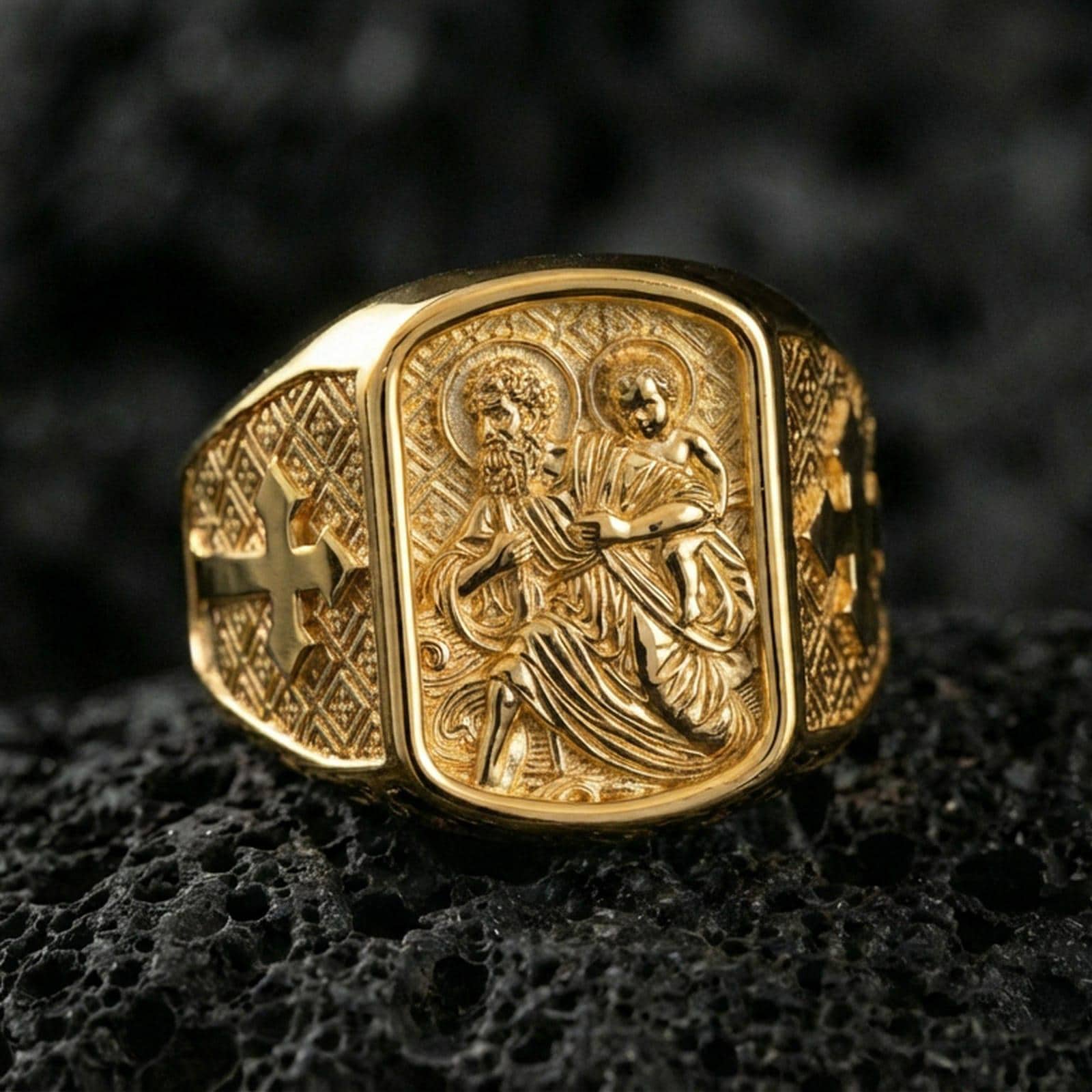 Gold plated Saint Christopher traveler ring on dark volcanic rock, carrying child relief engraving, Christian protection jewelry