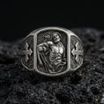 Load image into Gallery viewer, Oxidized sterling silver St Sebastian ring on volcanic rock, martyr saint relief signet, cross side panels and patterned band
