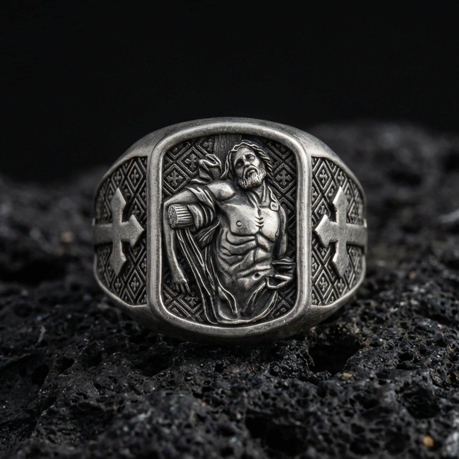Oxidized sterling silver St Sebastian ring on volcanic rock, martyr saint relief signet, cross side panels and patterned band
