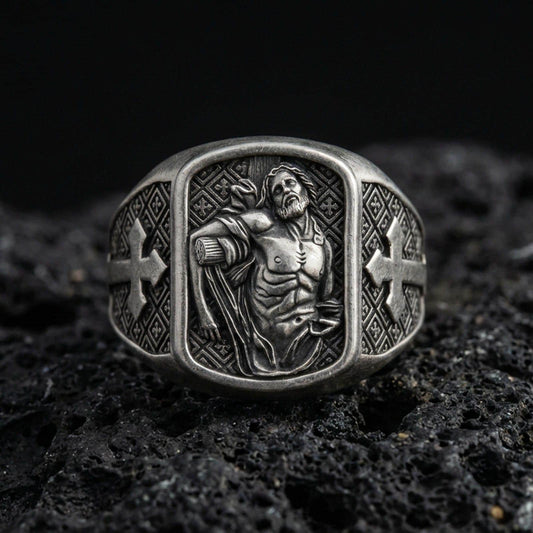 Oxidized sterling silver St Sebastian ring on volcanic rock, martyr saint relief signet, cross side panels and patterned band