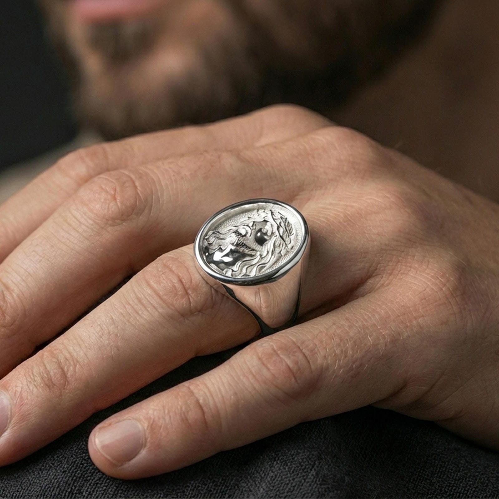 Polished silver Jesus portrait ring on hand, classic religious signet ring styling for daily wear