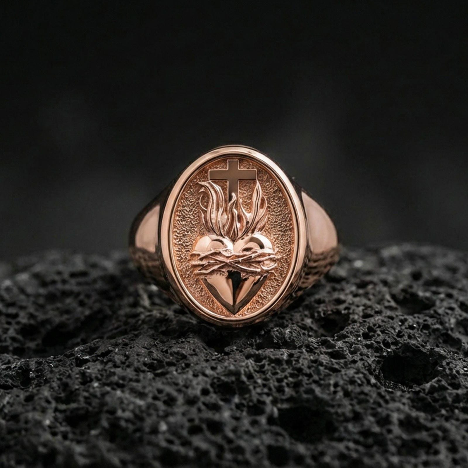 Rose gold plated Sacred Heart ring on volcanic stone, thorn-crowned heart emblem, Catholic devotional accessory