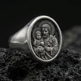Load image into Gallery viewer, Oxidized 925 sterling silver St Joseph signet ring on volcanic rock, Holy Family relief closeup

