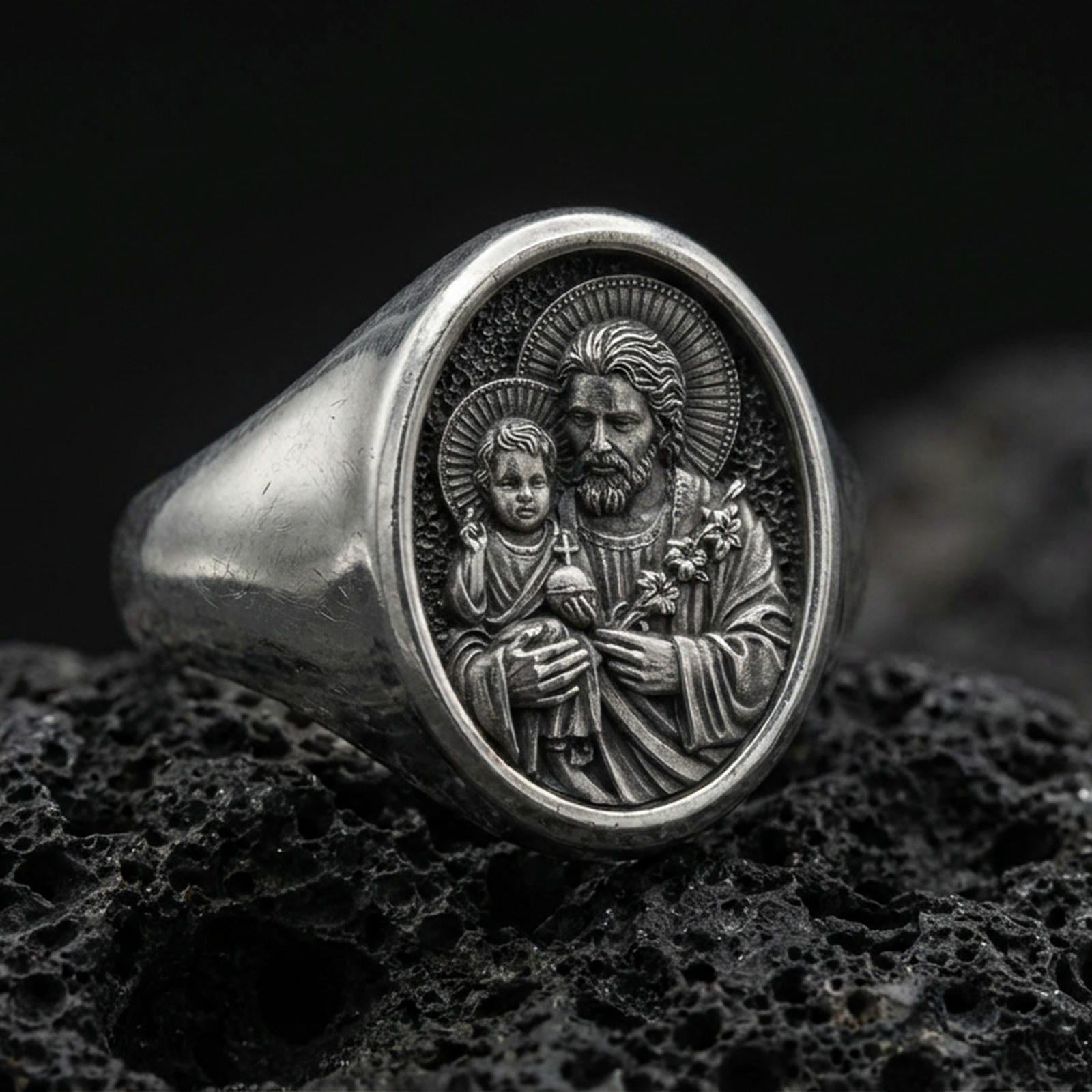 Oxidized 925 sterling silver St Joseph signet ring on volcanic rock, Holy Family relief closeup