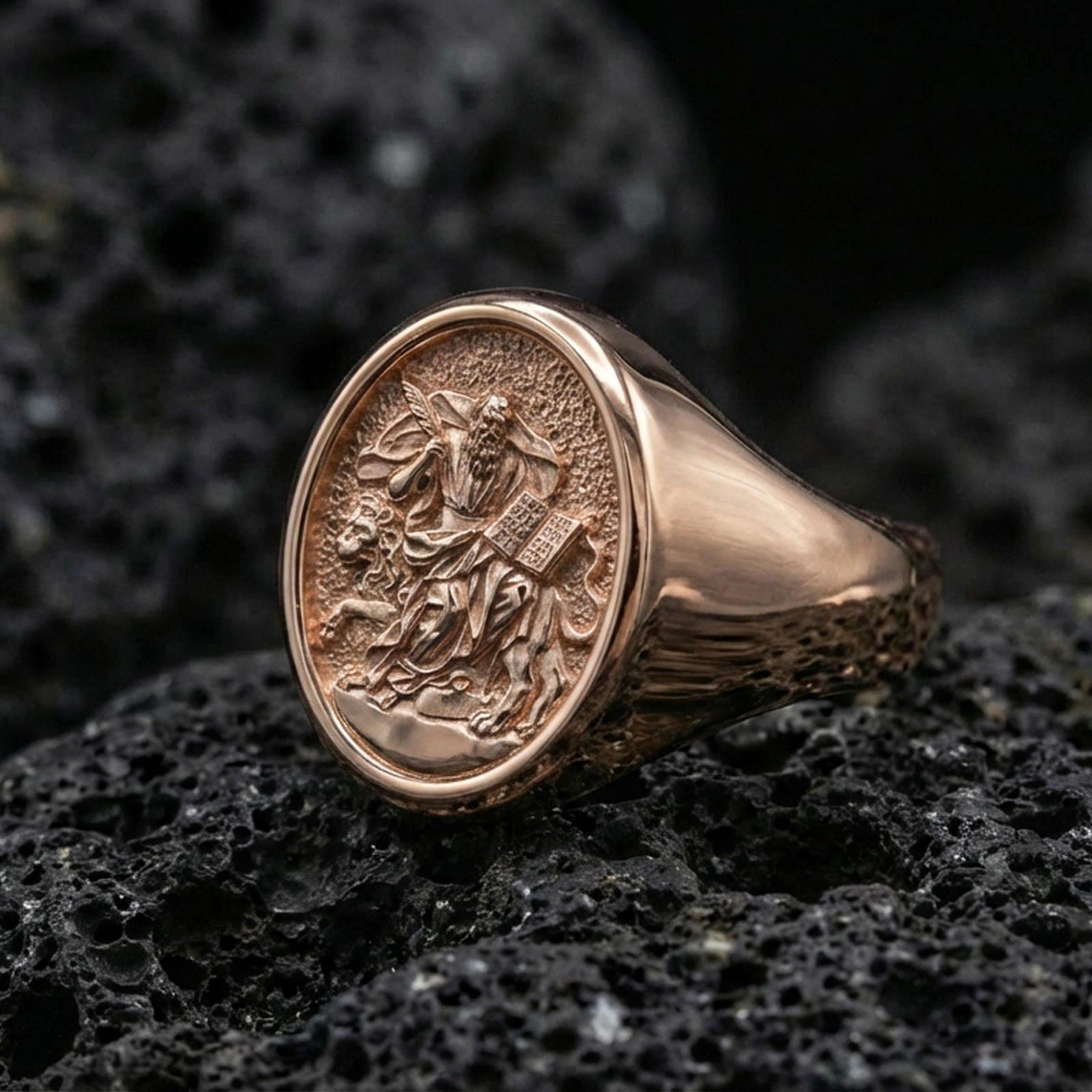 Rose gold plated Saint Mark ring on volcanic stone, evangelist lion signet ring closeup