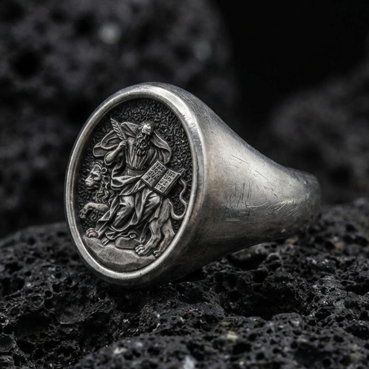 Oxidized 925 sterling silver St Mark signet ring on volcanic rock, winged lion and gospel relief
