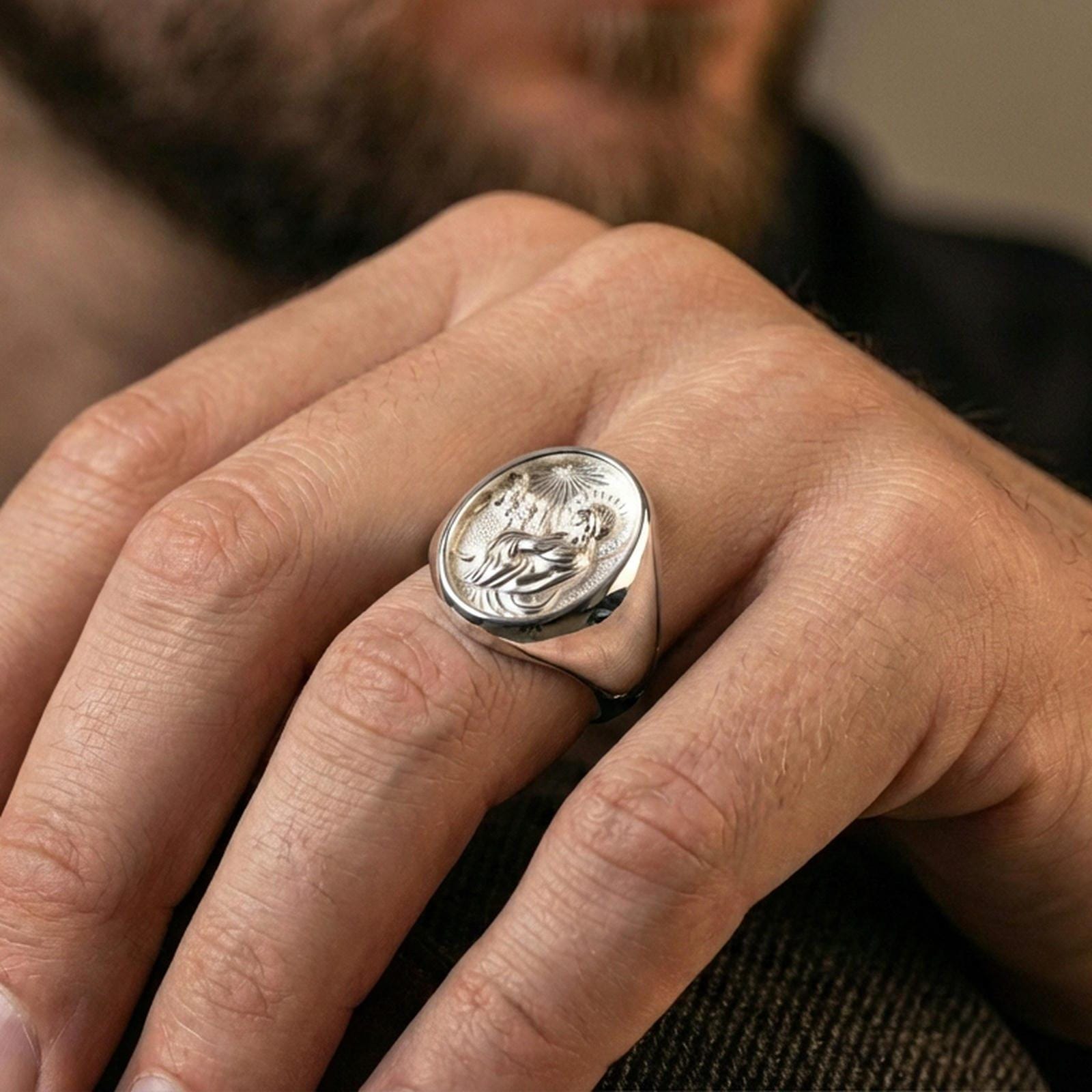 Polished silver Jesus Christ signet ring on hand, halo Christ profile religious mens ring