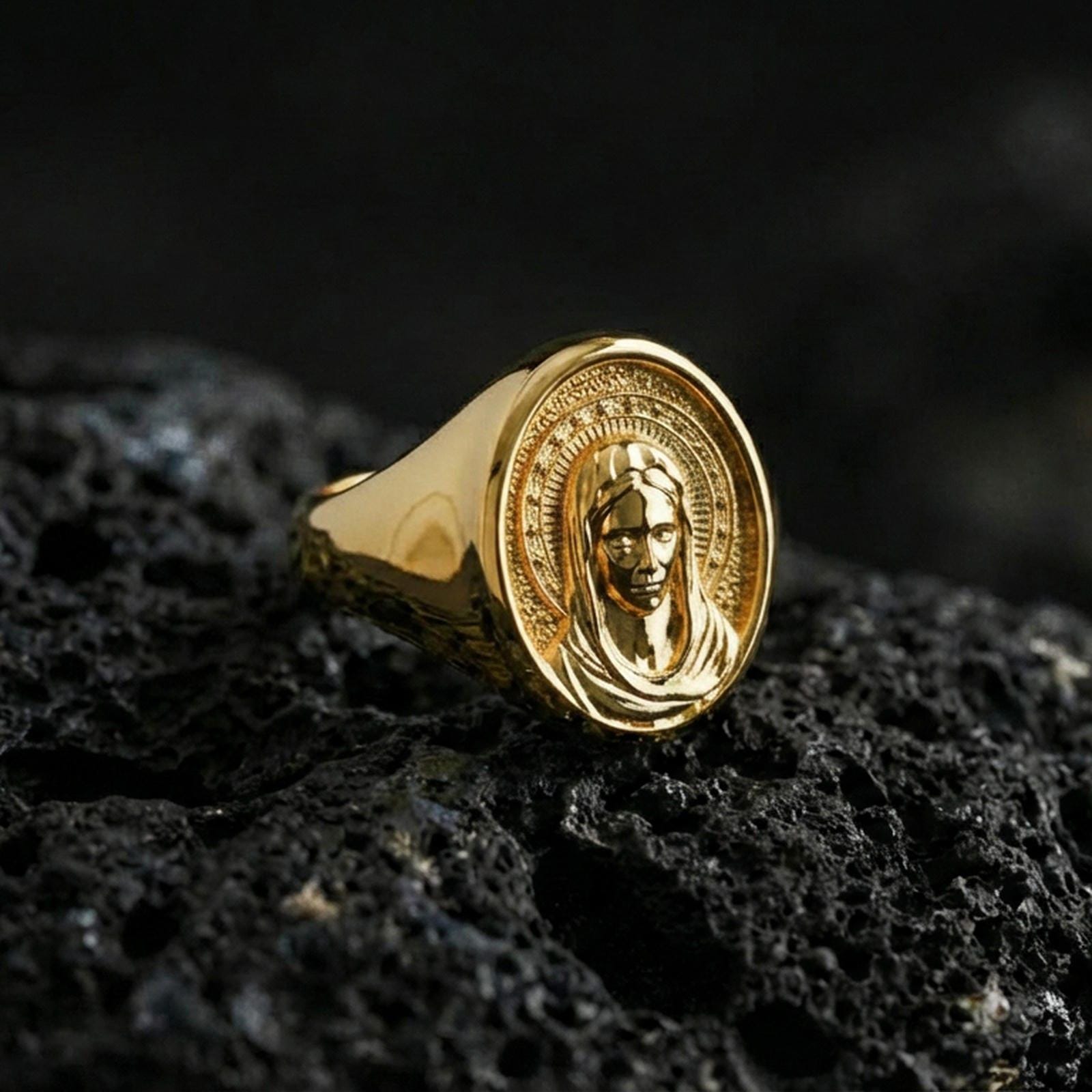 Gold plated Virgin Mary signet ring on dark volcanic rock, holy Mary portrait design, Christian jewelry gift