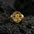Load image into Gallery viewer, Gold plated Jesus Christ signet ring on dark volcanic rock, icon-style Christ portrait, religious accessory
