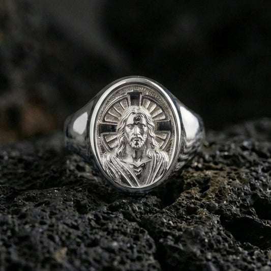 Polished silver Jesus Christ signet ring on porous volcanic stone, radiant cross halo design, Christian jewelry