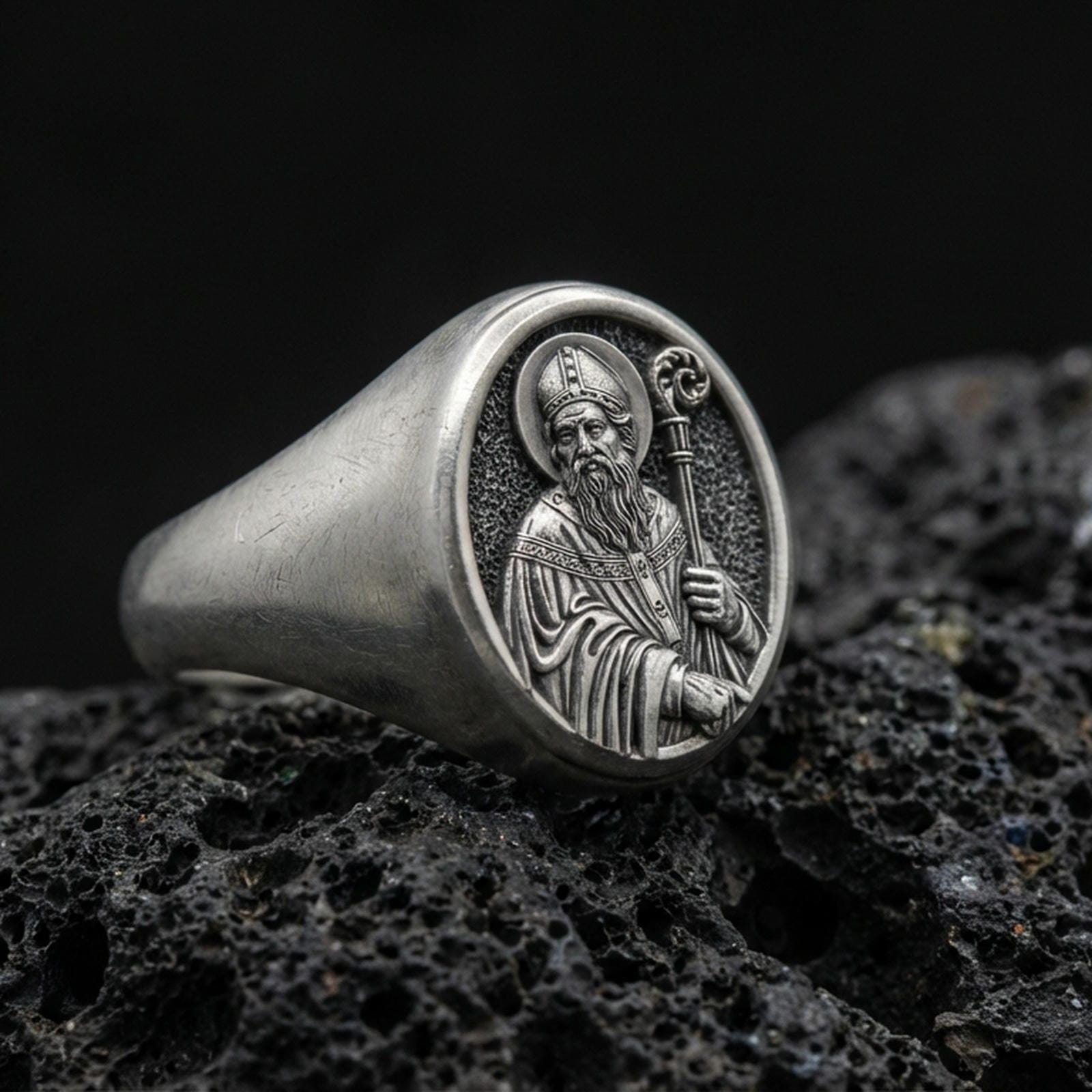 Oxidized 925 sterling silver Saint Benedict signet ring on volcanic rock, holy protector portrait relief, Catholic jewelry