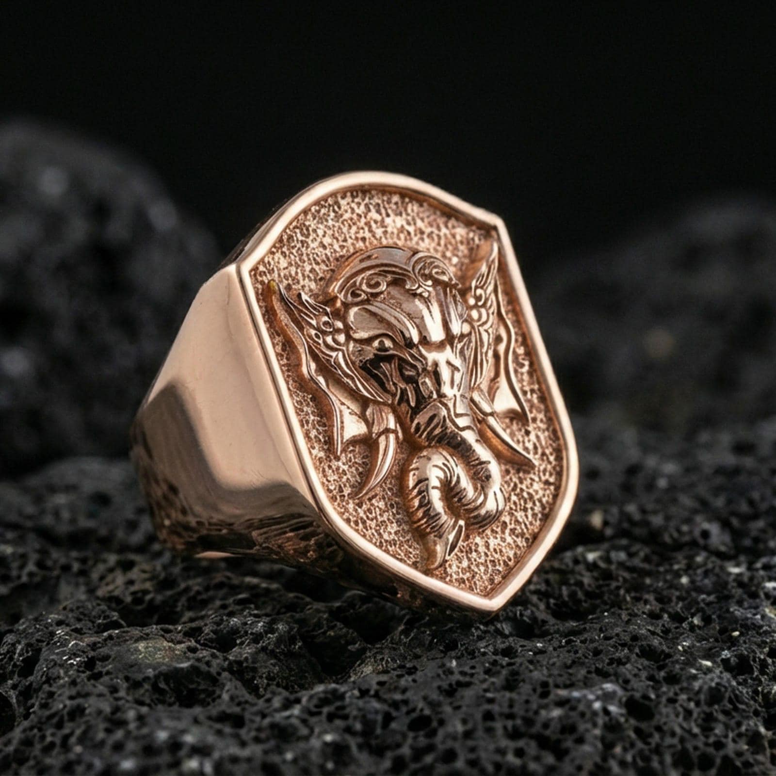 Rose gold plated Lord Ganesha signet ring on volcanic stone, sacred Ganesh motif, symbolic spiritual accessory