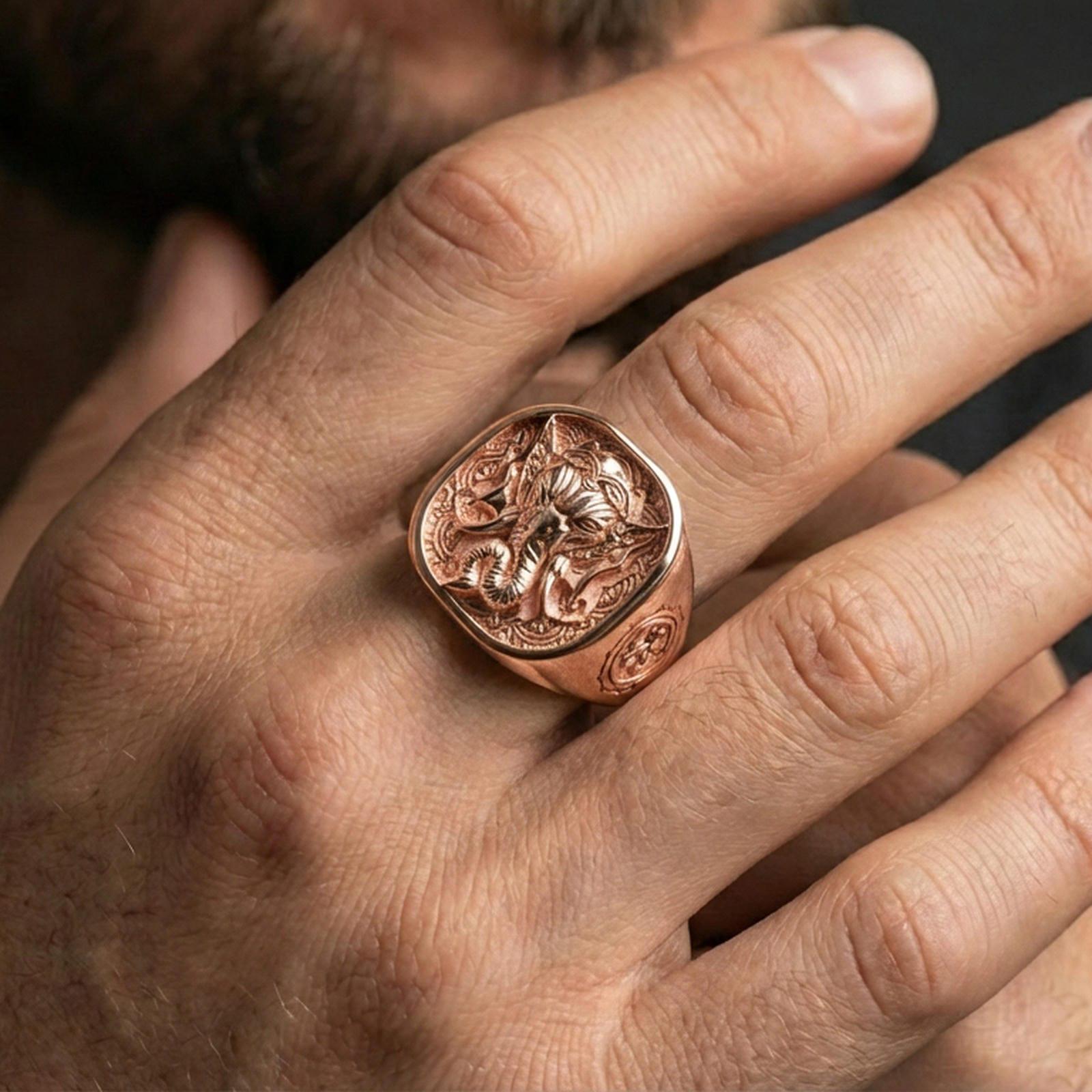 Rose gold plated Lord Ganesha ring worn on finger, ornate Indian motif, meaningful spiritual accessory