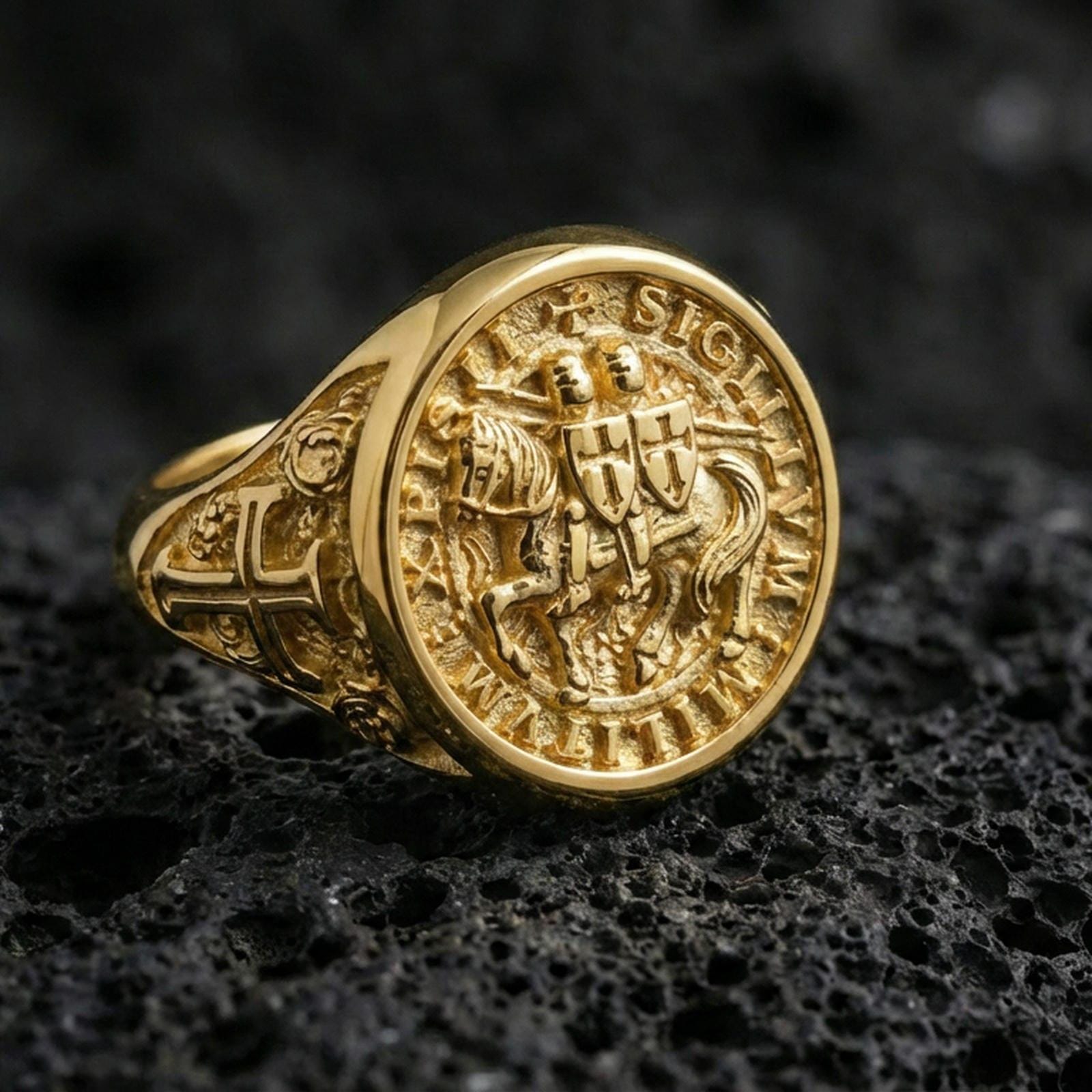 Gold plated Knights Templar signet ring on dark volcanic rock, Sigillum Militum Xpisti emblem, gothic medieval jewelry