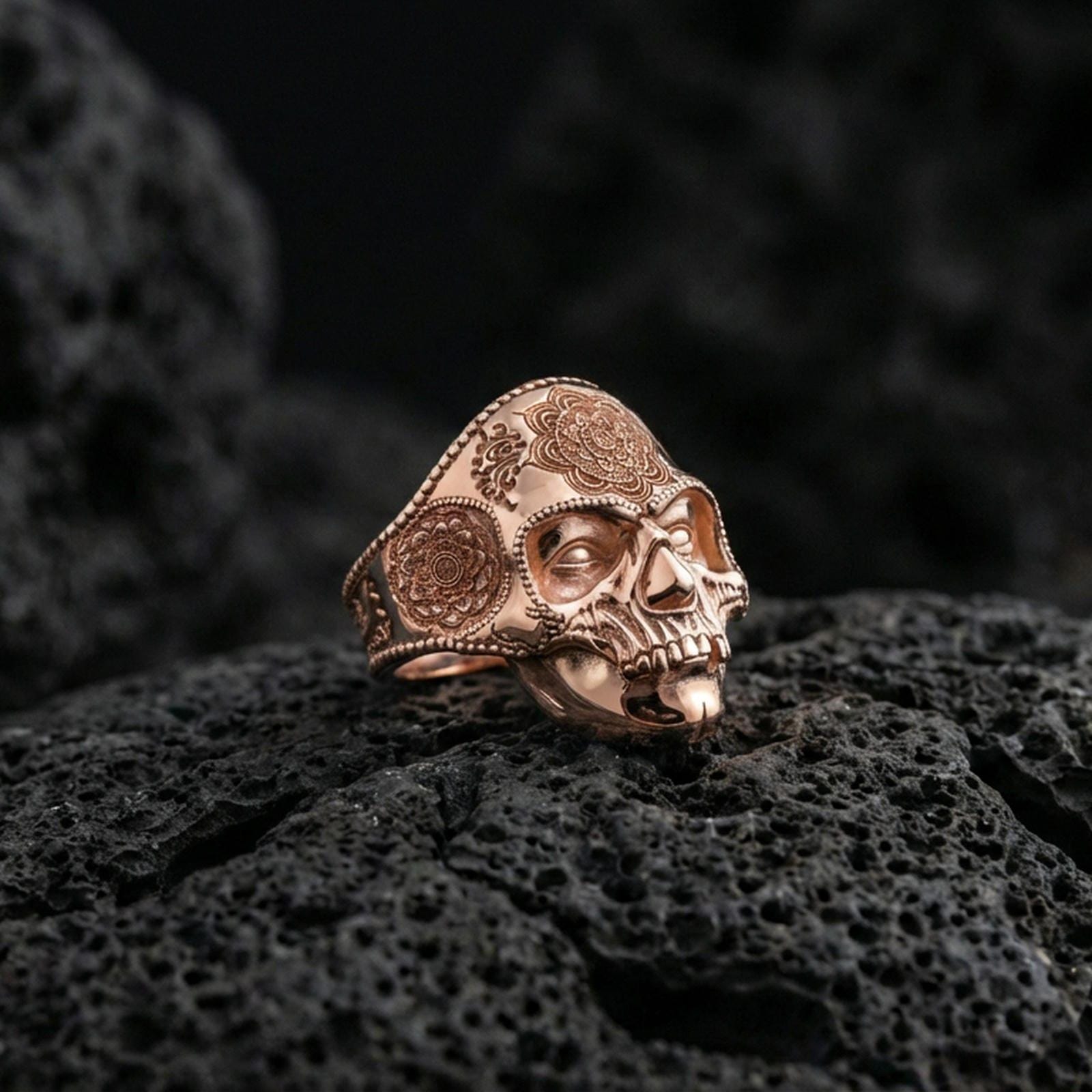 Rose gold plated skull mandala ring on volcanic stone, ornate mandala engraving, gothic luxe jewelry