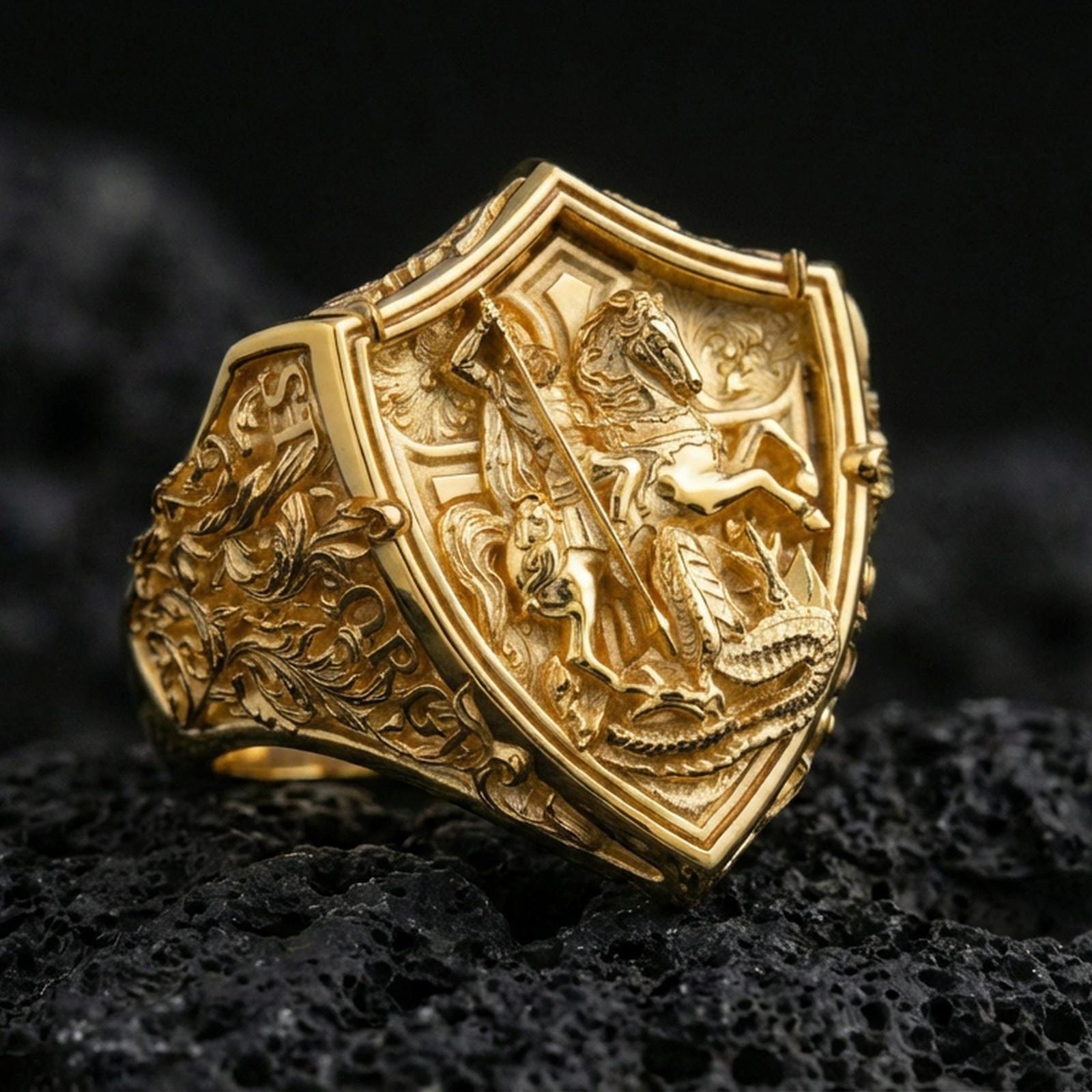 Gold plated sterling silver Saint George dragon slayer ring on dark volcanic rock, heroic faith symbol, medieval shield ring